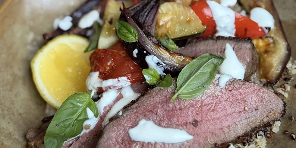 Butterflied leg of lamb with baked veg